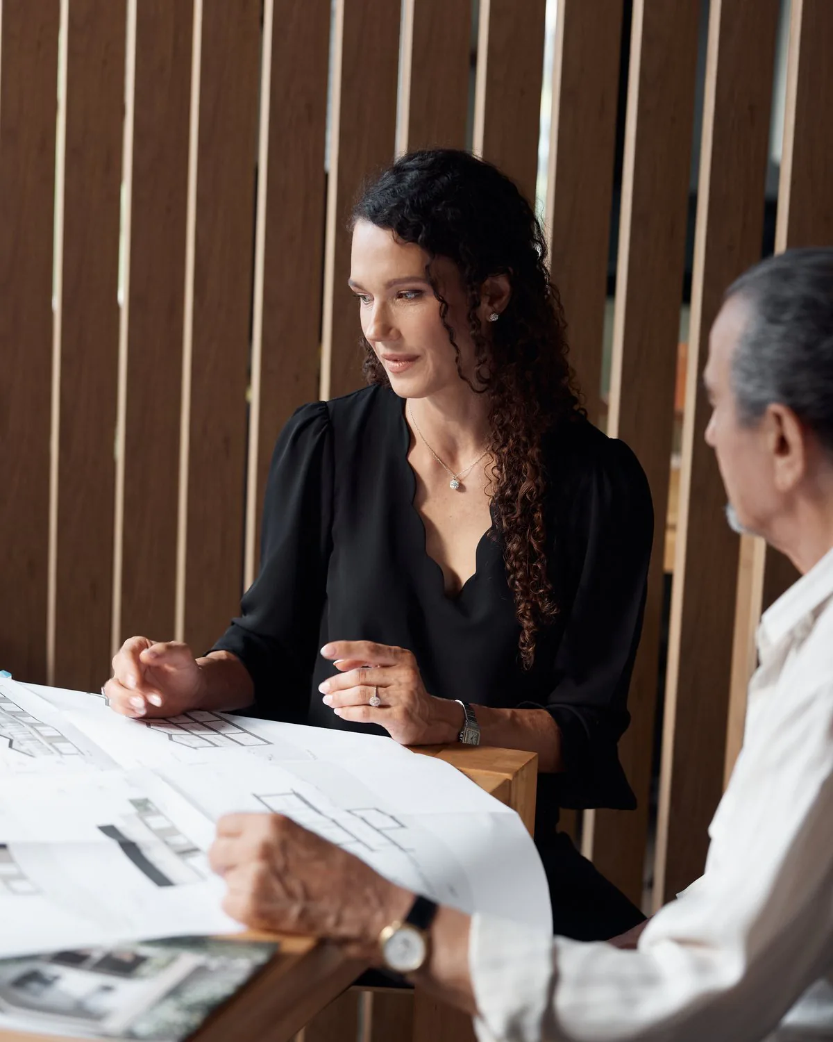 Barbara et Giorgio Bordogna à la table de travail, penchés sur les plans d'un projet